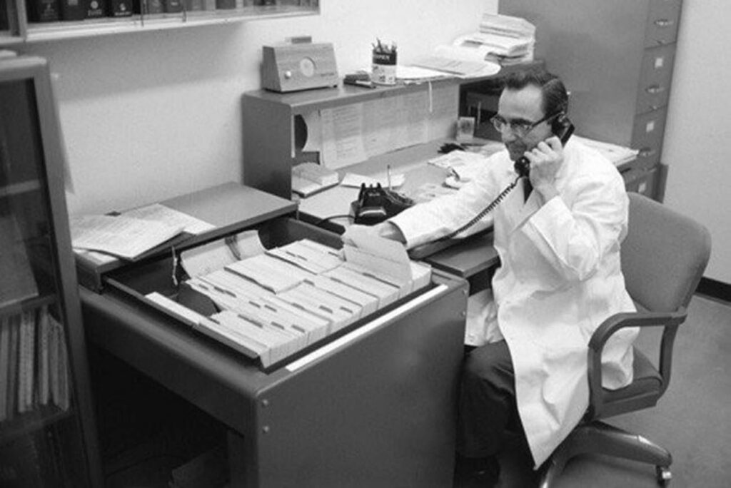 Albert L. Picchioni, PhD, provides a phone consultation using one of 2,000 index cards he created with information on chemicals and their health effects. Picchioni, professor and acting dean of the college from 1975-1977, created the Arizona Poison Control System, a precursor to the Arizona Poison and Drug Information Center.